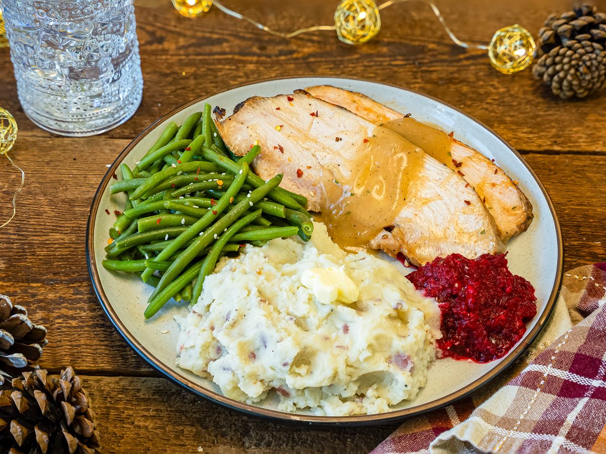 Turkey dinner with mashed potatoes, green beans and cranberry relish